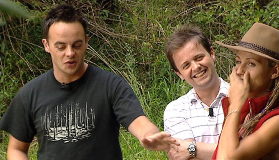 a man wearing a black shirt with trees on it