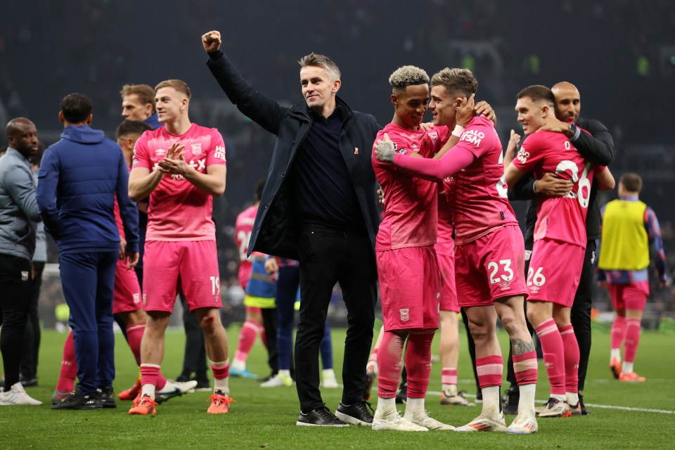 a group of soccer players wearing pink jerseys with the number 23 on them