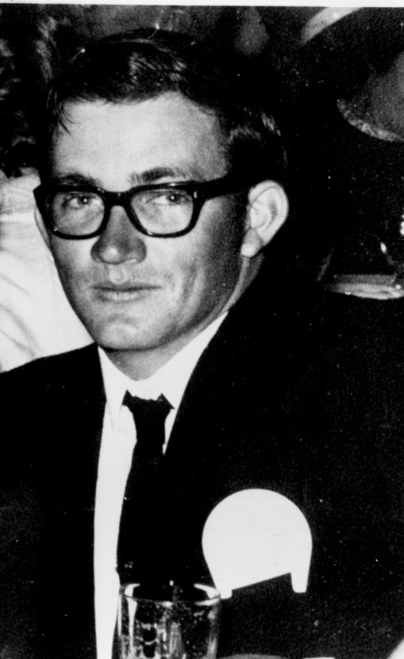 a black and white photo of a man wearing glasses