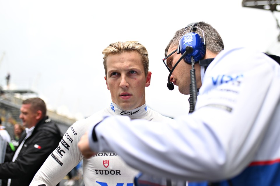 a man wearing a tudor shirt talks to another man