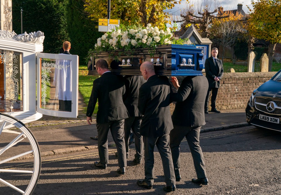 Pallbearers carry Liam’s coffin which was adorned with white roses