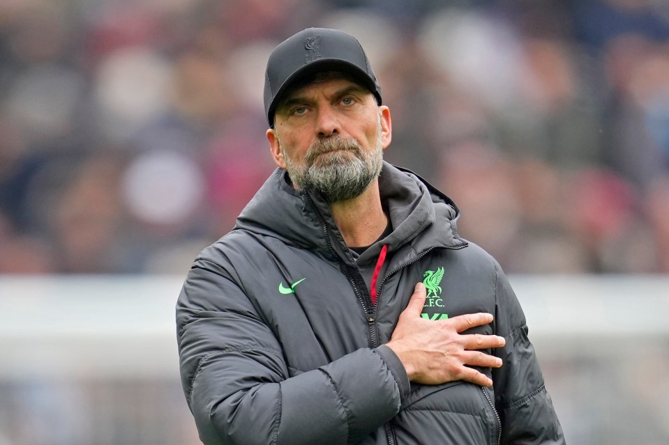 a man wearing a jacket that says liverpool on it