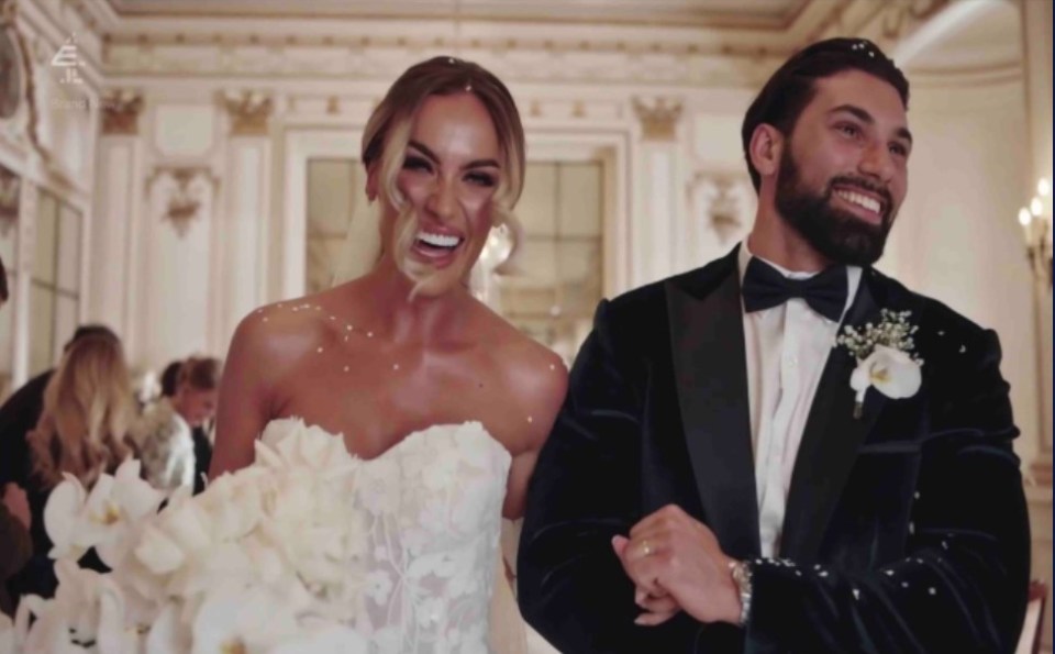 a bride and groom walk down the aisle at their wedding