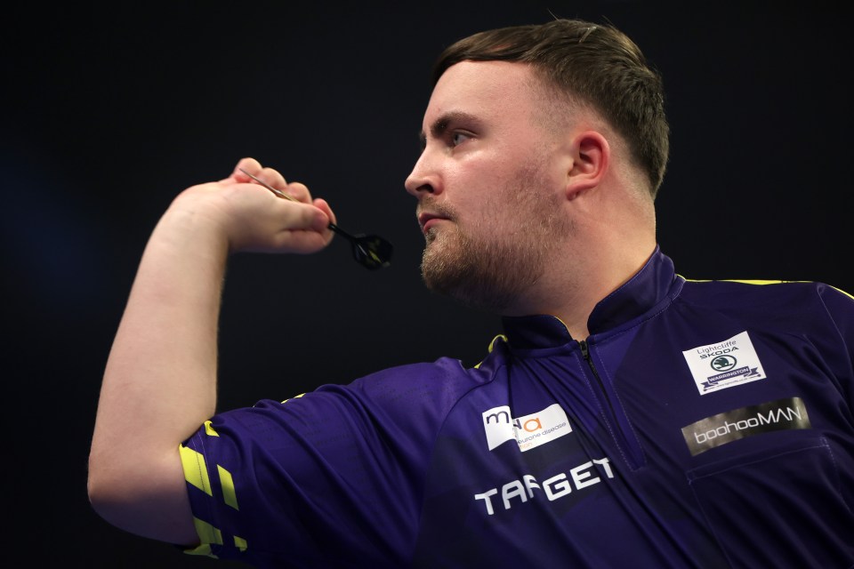 a man wearing a target shirt holds a dart in his hand