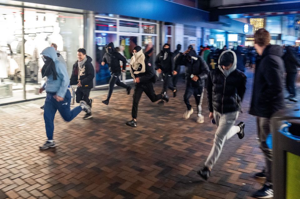 Rioters run through the streets amid disturbing clashes in Amsterdam between Israelis and an anti-Semitic mob