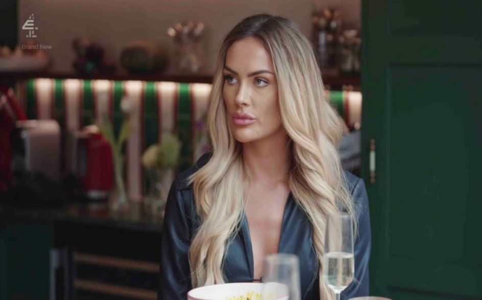 a woman is sitting at a table with a glass of wine and a bowl of food and the channel 4 logo is visible