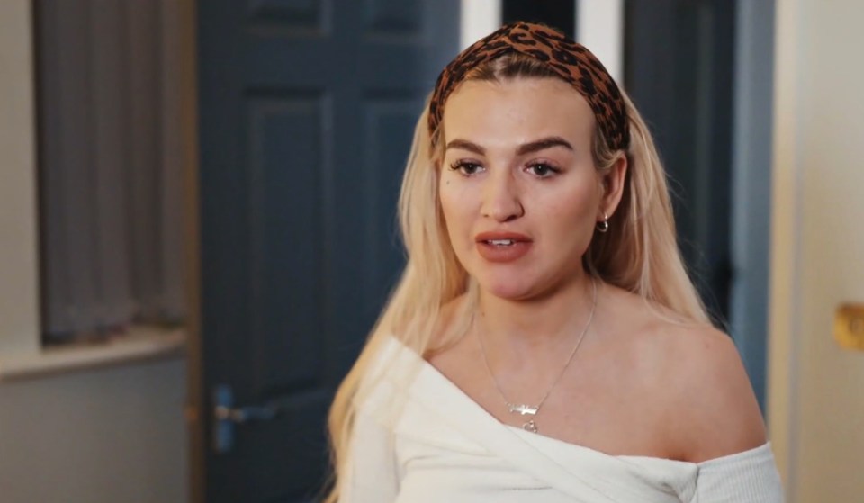 a woman wearing a leopard print headband and a white top