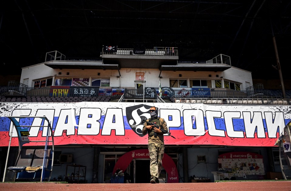 a man in a mask stands in front of a banner that says ' taba & pocch '