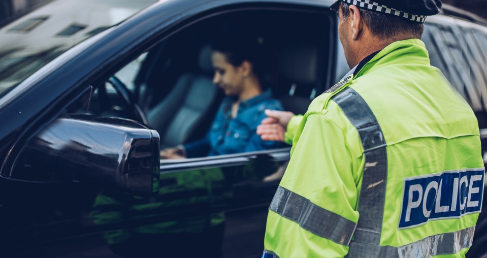 a police officer talking to a woman in a car