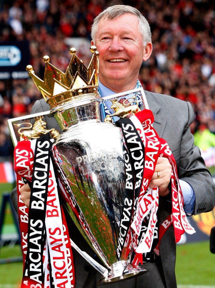 a man holding a trophy with barclays ribbons around it