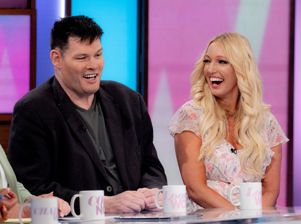 a man and a woman are sitting at a table with coffee mugs that say channel