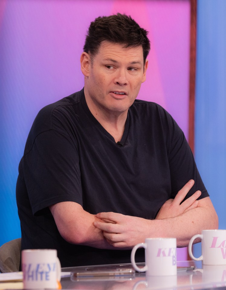 a man sits at a table with a cup that says white on it