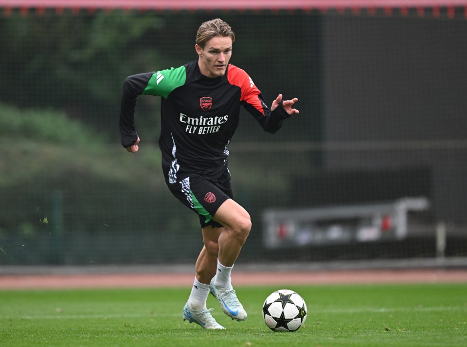 a soccer player wearing a jersey that says emirates fly better