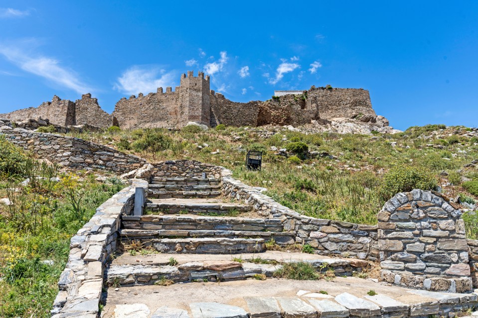 stone stairs leading up to a castle on top of a hill