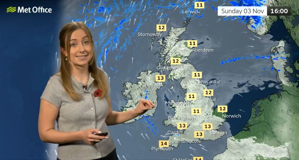 a woman stands in front of a met office weather map