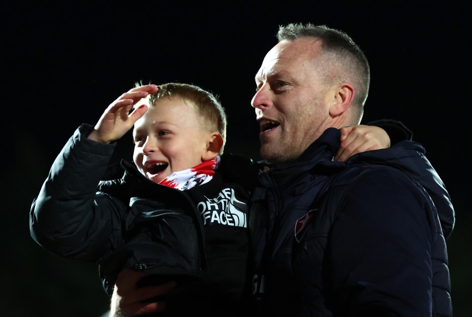 Michael Flynn celebrated victory with his son on the pitch