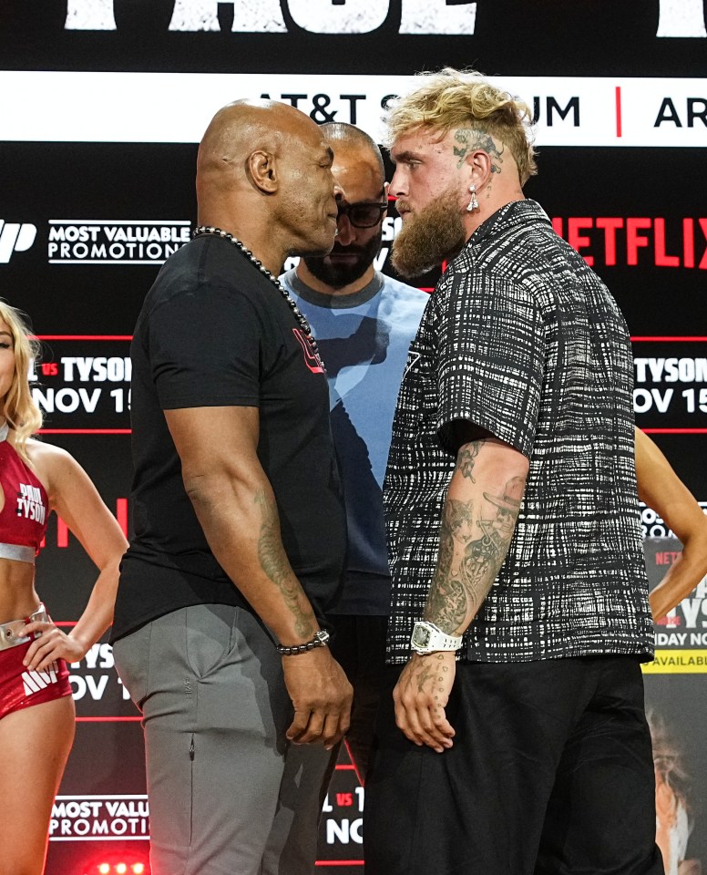 two men are facing each other in front of a sign that says netflix