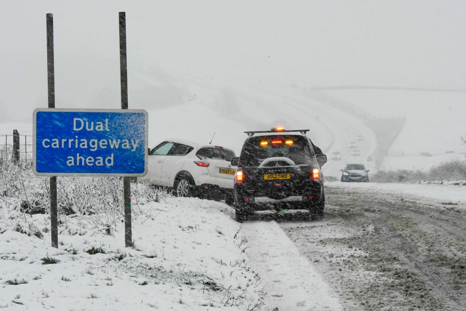 a blue sign that says dual carriageway ahead