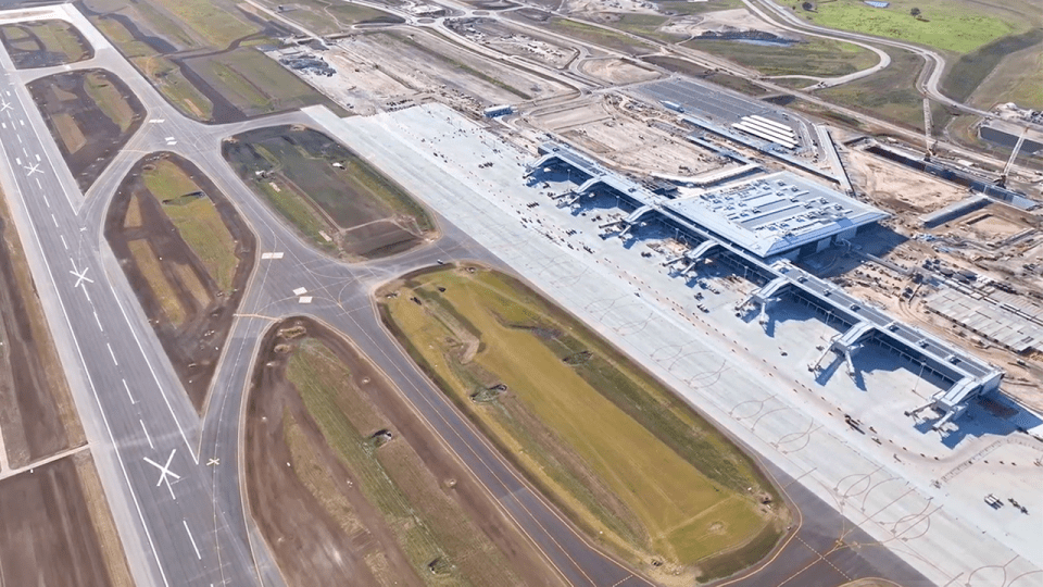 an aerial view of a large airport with runways and terminals