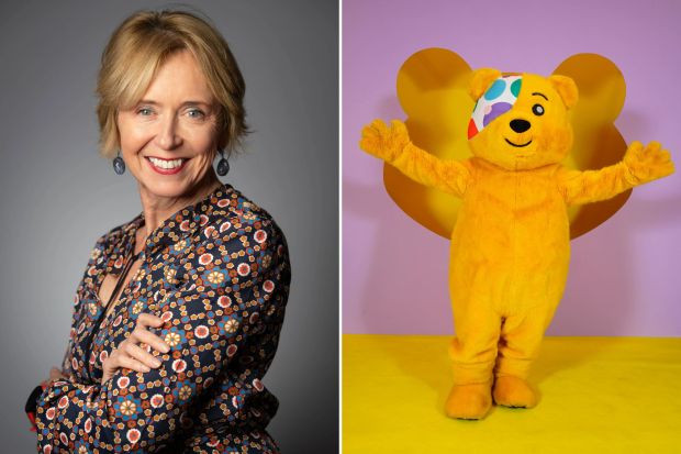 a woman next to a yellow teddy bear with wings