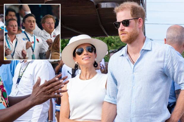 prince harry and meghan markle are standing next to each other