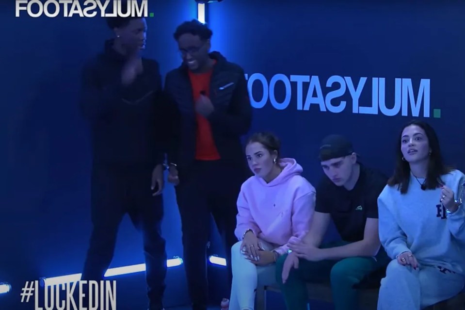 a group of people sitting in front of a sign that says foota2ylum