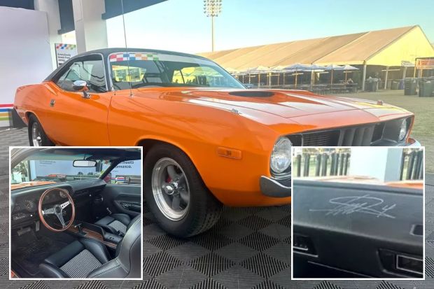 a picture of an orange car with a signature on the door