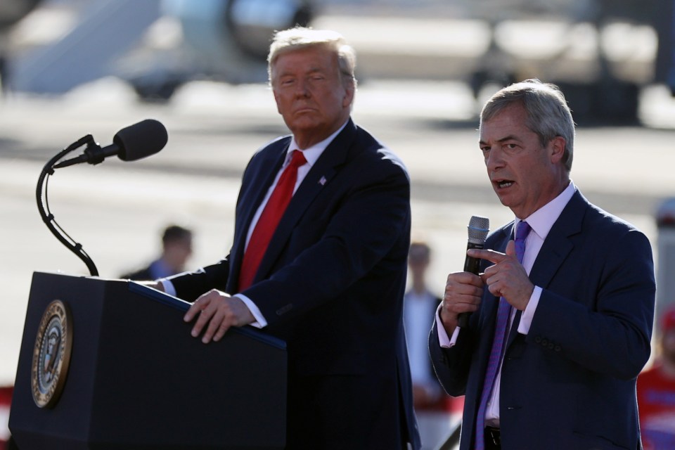 a man in a suit stands at a podium while another man speaks into a microphone