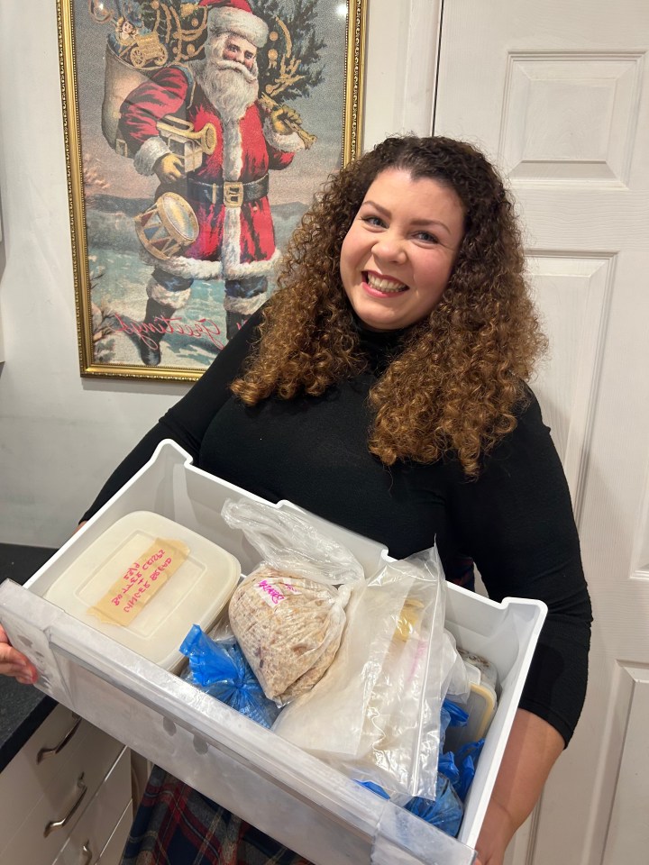 a woman is holding a container of food with a sticker on it that says " chicken noodle soup "