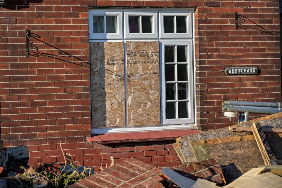 Multiple boarded up windows and entrances