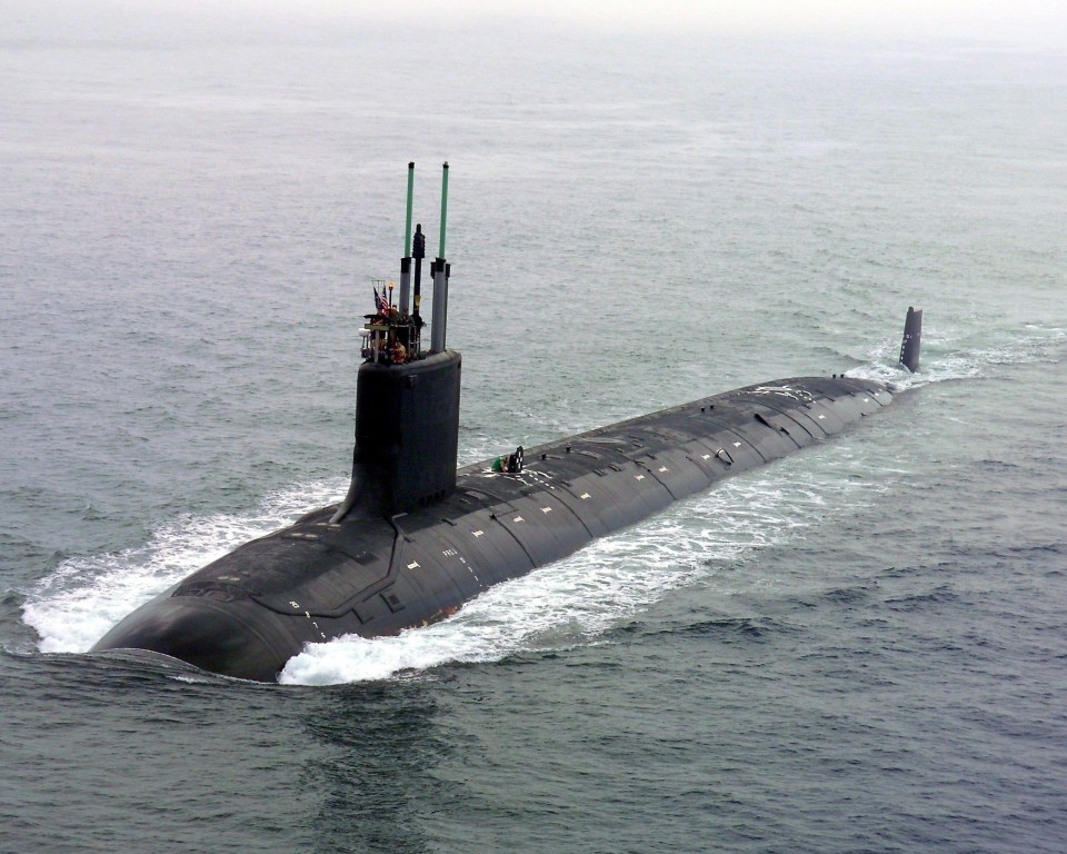 a large submarine is floating on top of a body of water