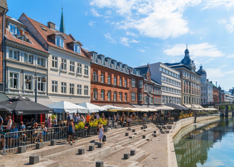 a row of buildings with umbrellas that say carlsberg on them