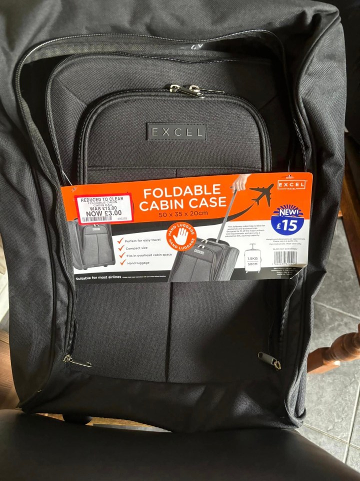 a black excel foldable cabin case sits on a chair