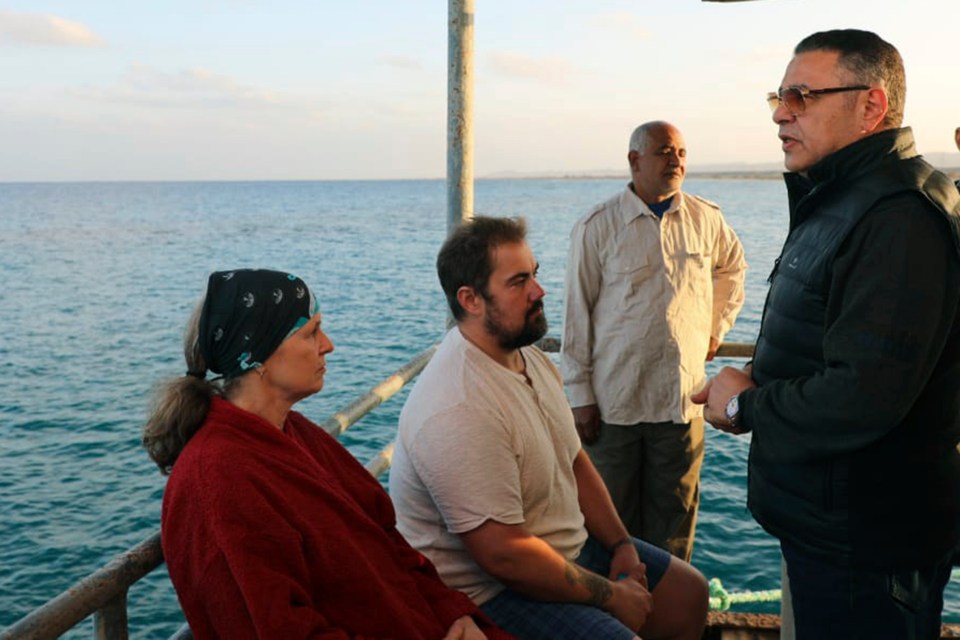 Red Sea governor Amr Hanafi, right, speaks to survivors