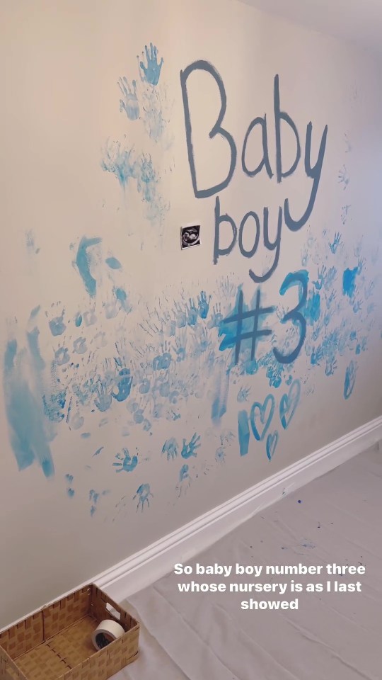 The nursery currently has the announcement and her sons' handprints on the wall