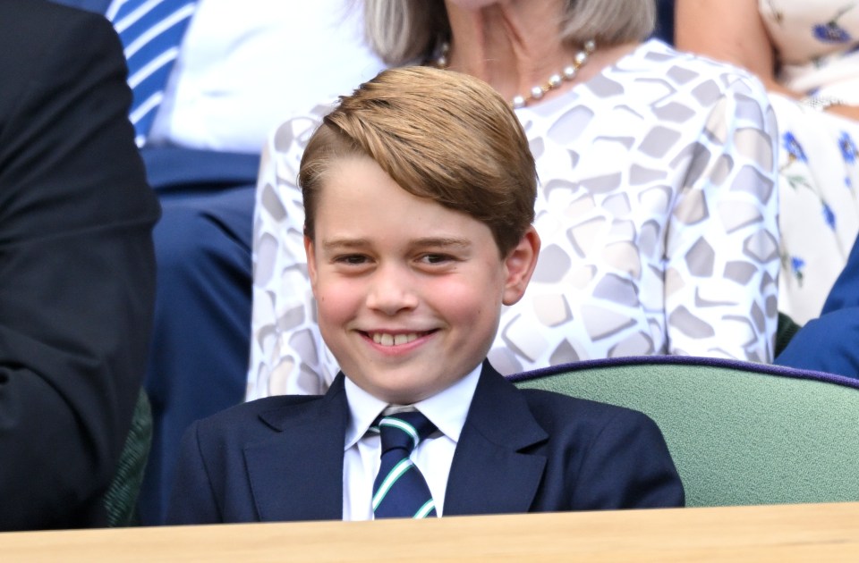 a young boy in a suit and tie smiles for the camera