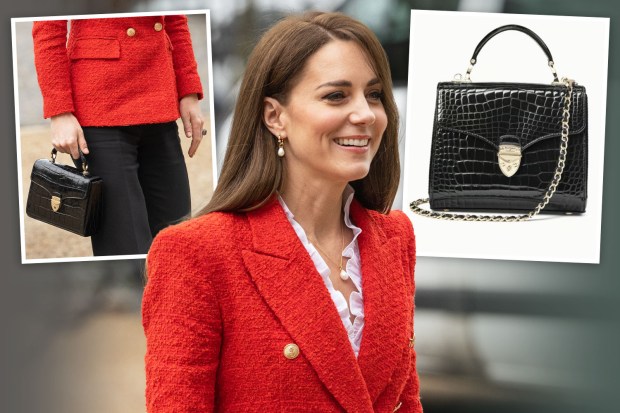 a woman in a red jacket is holding a black purse