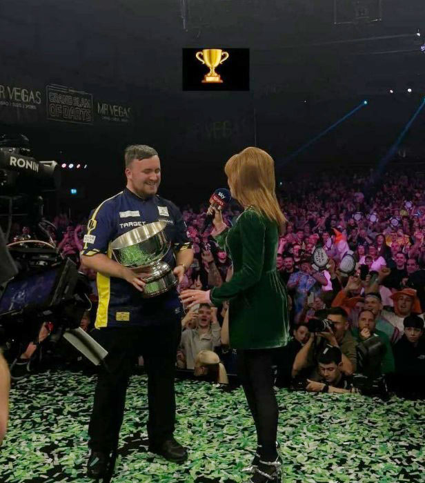 a man in a target shirt is holding a trophy