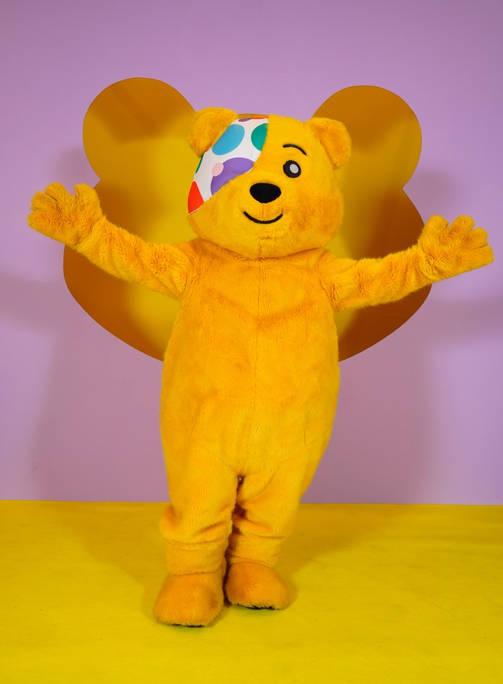 a yellow teddy bear with a bandage on his eye