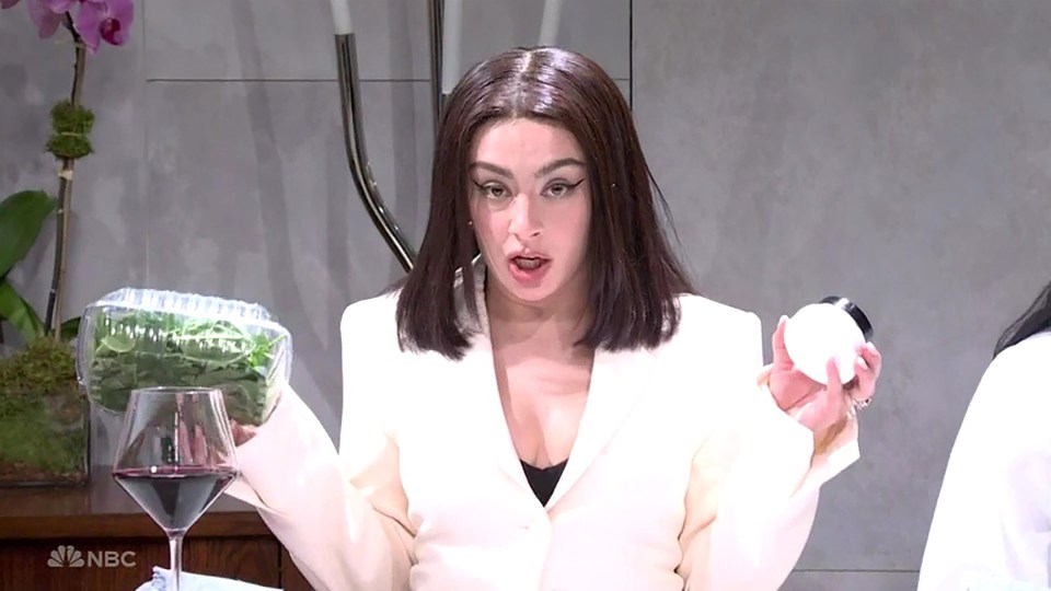 a woman in a white jacket is holding a container of spinach and an egg in front of a nbc logo