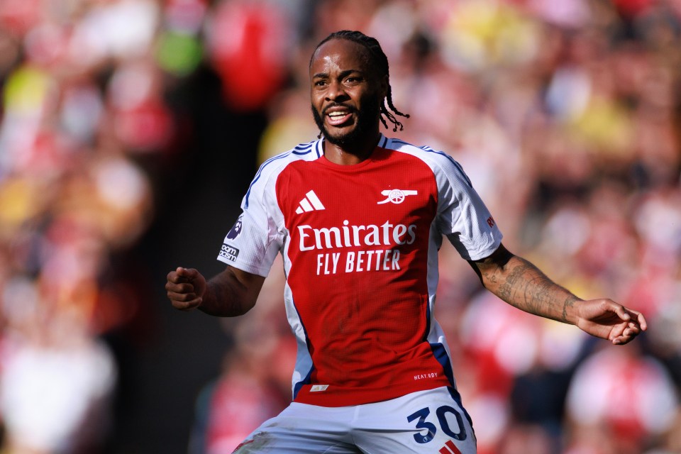 a soccer player wearing a red emirates fly better jersey