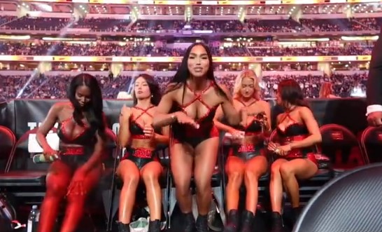 a group of cheerleaders are sitting in chairs in a stadium .