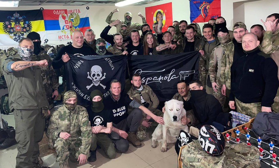 a group of soldiers posing for a picture with a flag that says blue prop