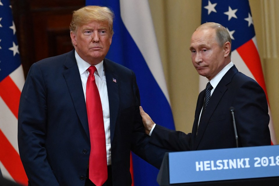 two men standing in front of a podium that says helsinki 2018