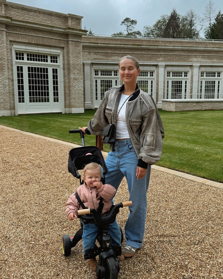 a woman is pushing a baby in a stroller