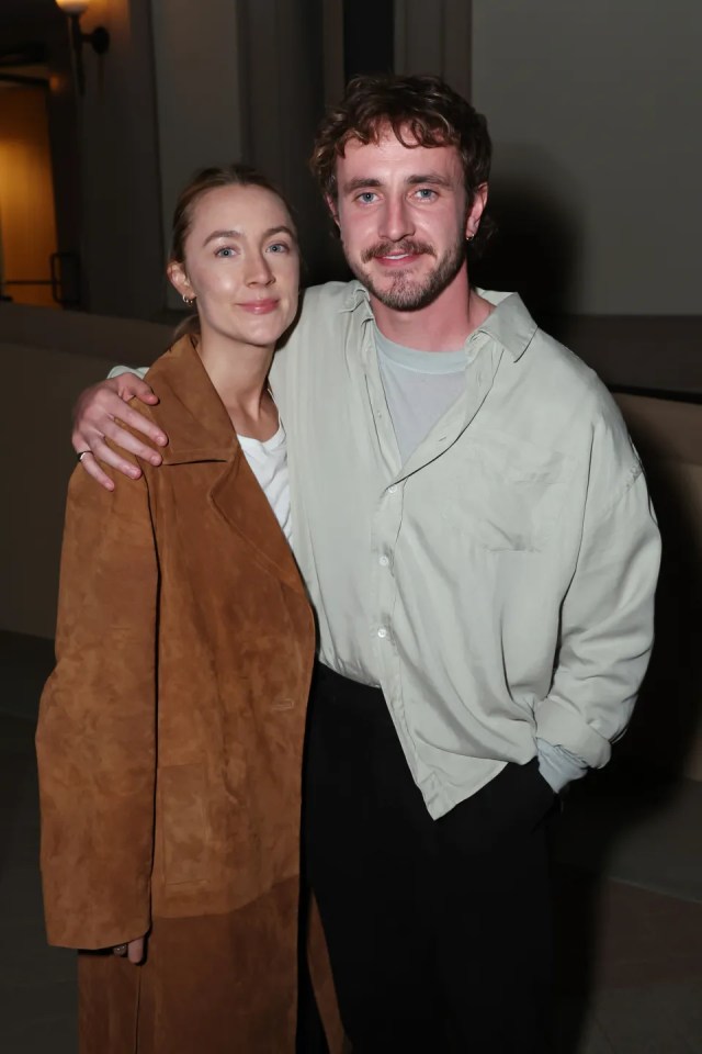 a man and a woman pose for a picture together