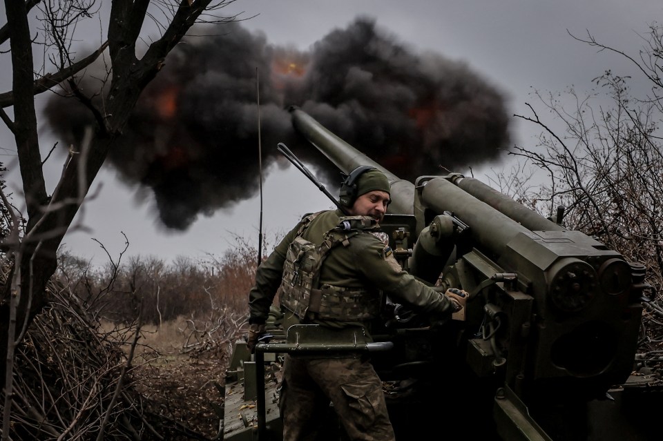 A Ukrainian soldier fires a howitzer on the front line