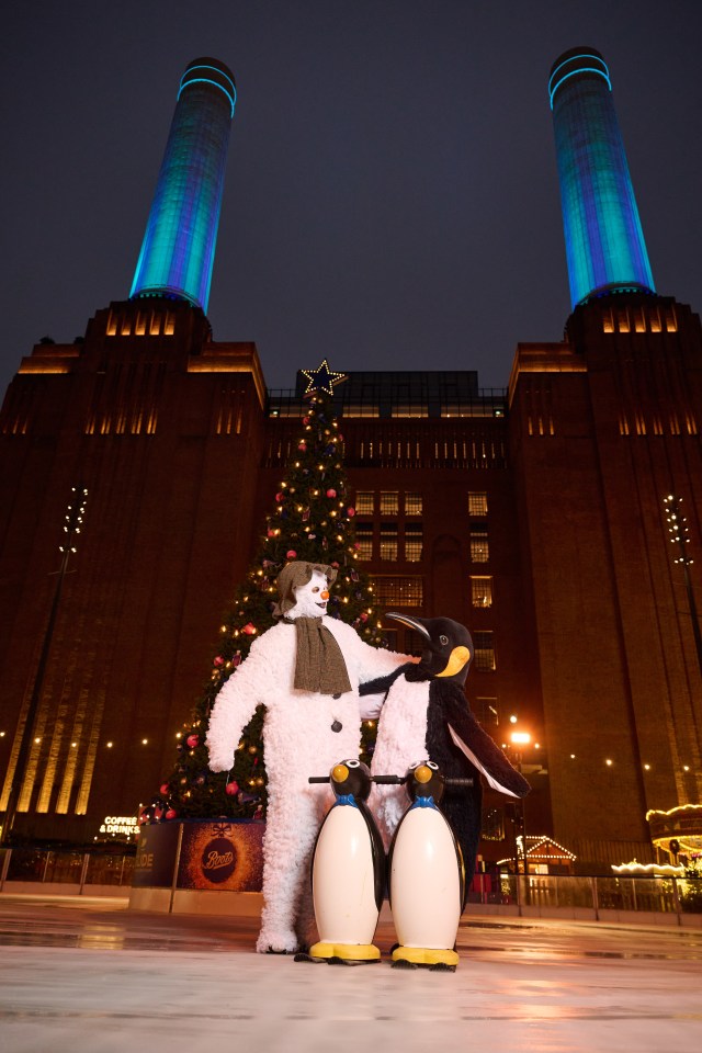 a snowman and two penguins are standing in front of a christmas tree