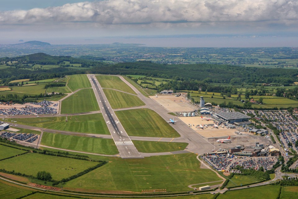 an aerial view of an airport with planes on the runway