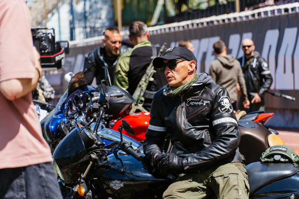 a man sits on a harley davidson motorcycle